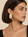 ATTICO gold-ivory-oval-earrings editorial portrait